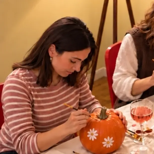 an orange pumpkin painted with white flowers